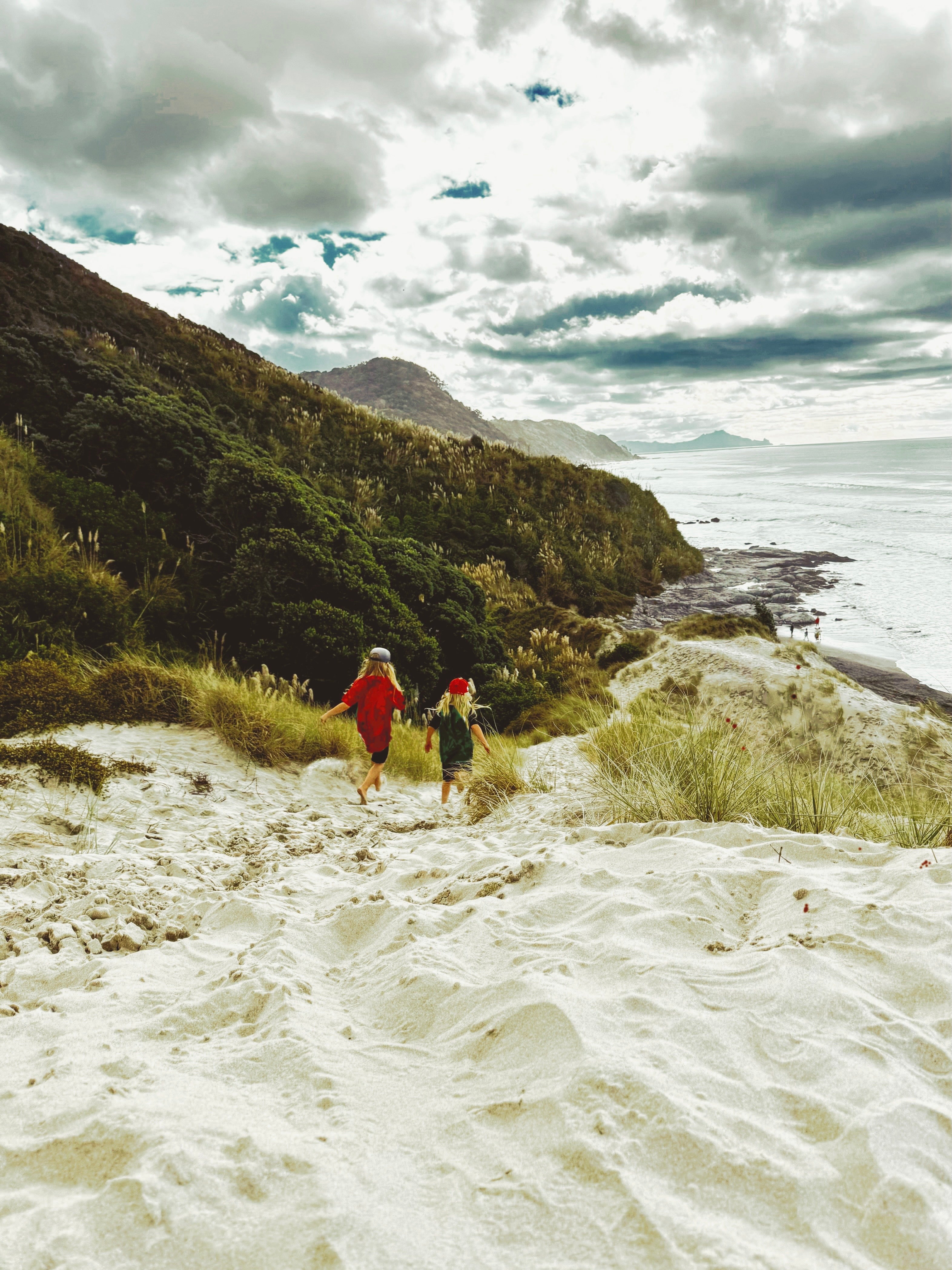 Two children running down sand dune core memory