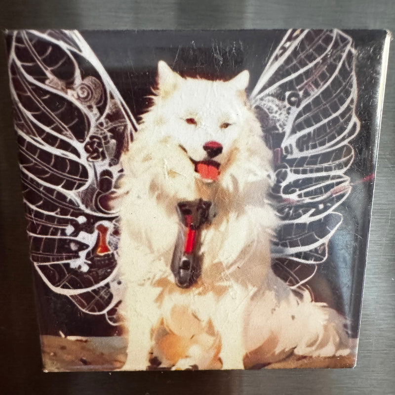 Fridge magnet with a design of a white dog wearing a harness on a black background with painted angel wings 