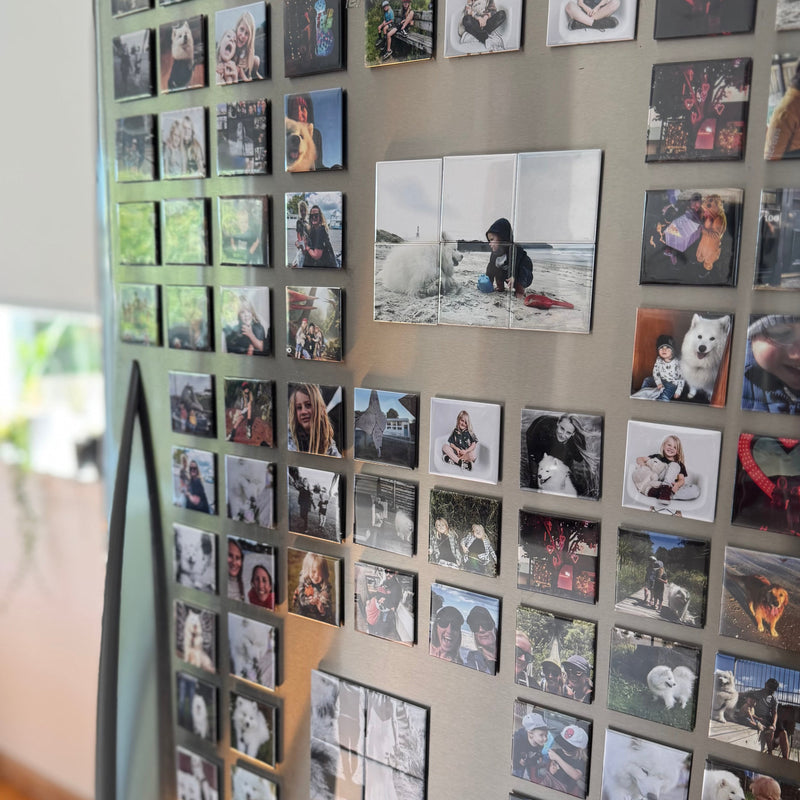 Fridge with a collection of personalised photos attached to it.